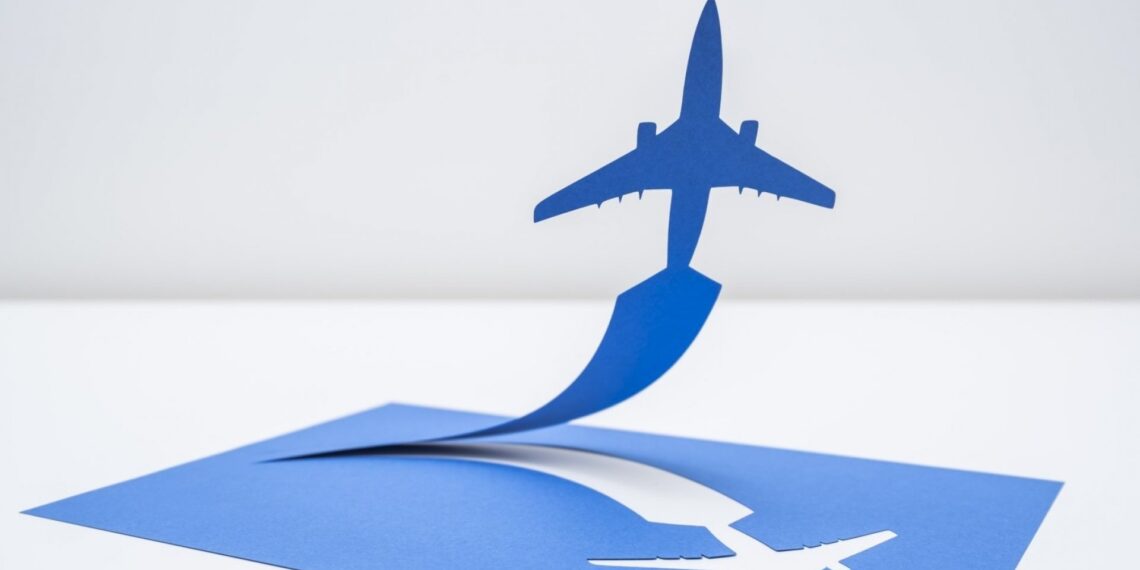 an airplane cut out of a paper